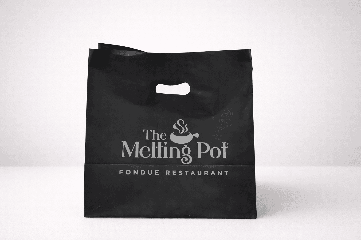 Black die-cut handle plastic bag with restaurant branding